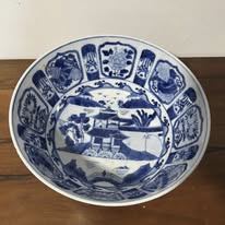 Blue and white porcelain bowl with oriental motifs.